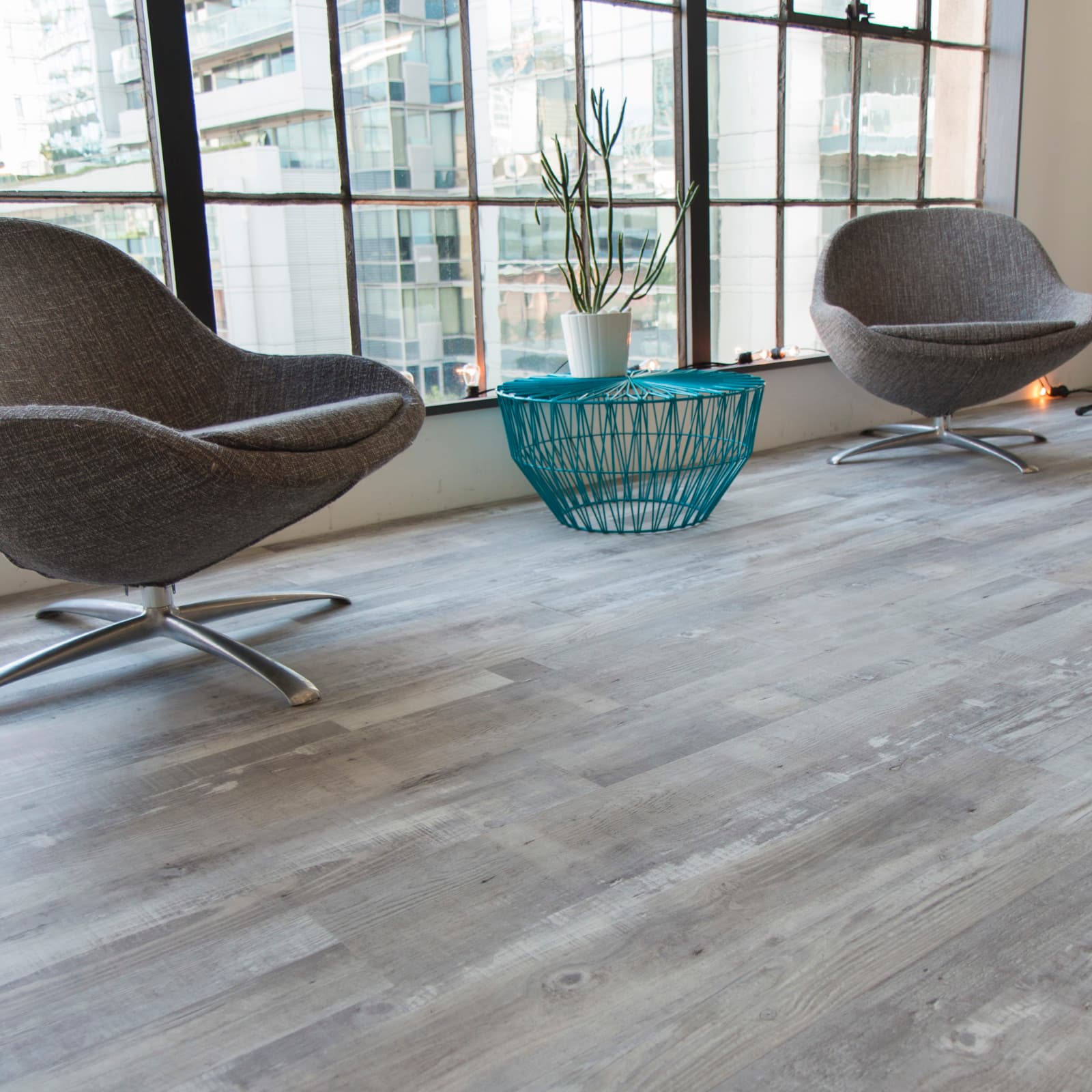 CALI Vinyl Select Gray Ash - warm gray ash-look waterproof vinyl plank in a contemporary rental space